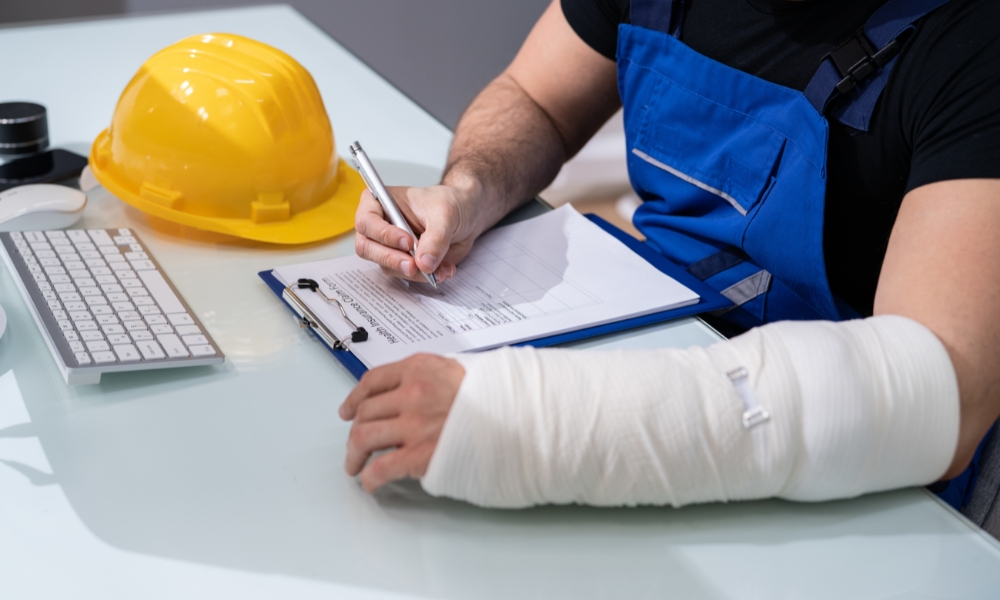 Startup employee reporting workplace injury with HR team handling workers compensation claim process